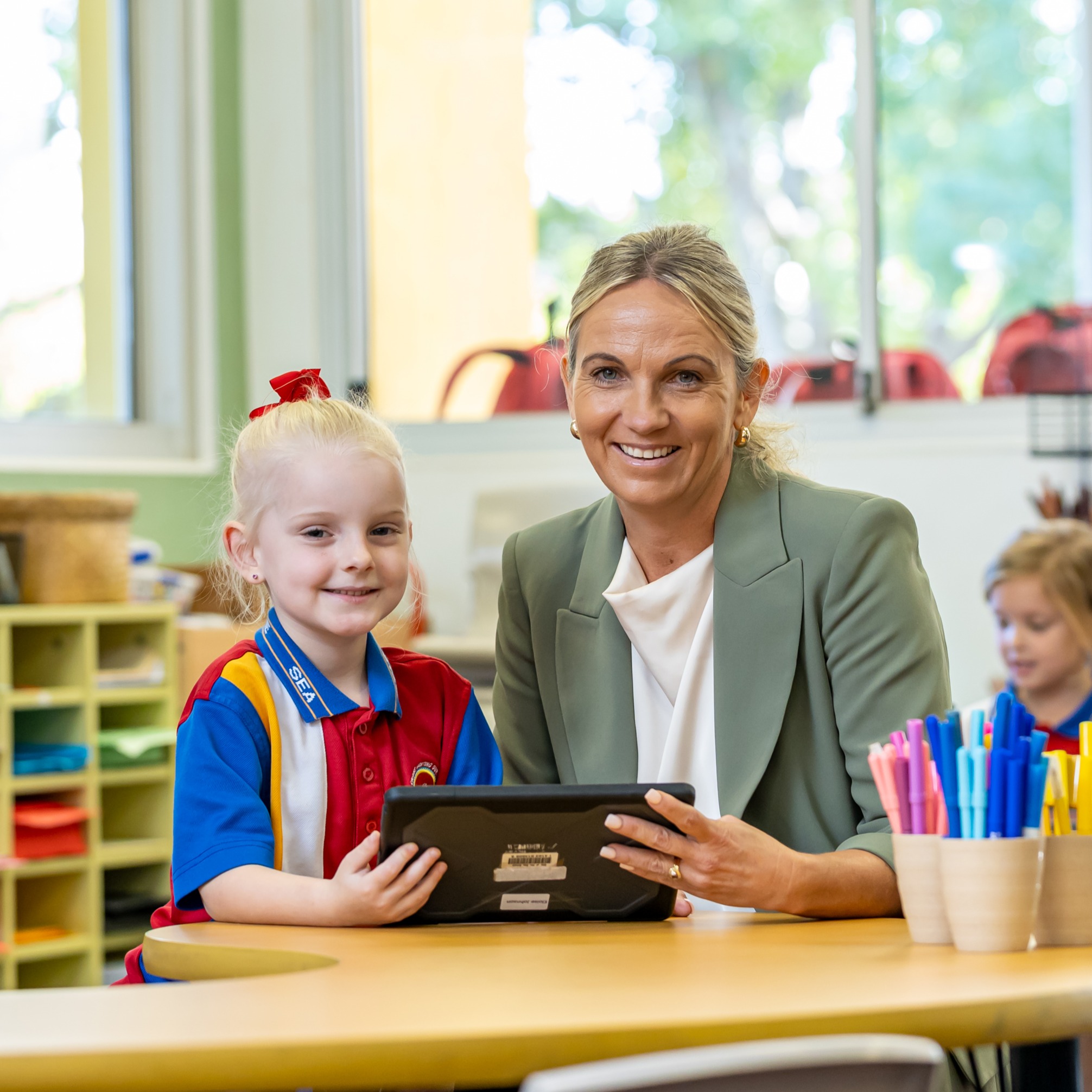 student holding a book in a classroom
