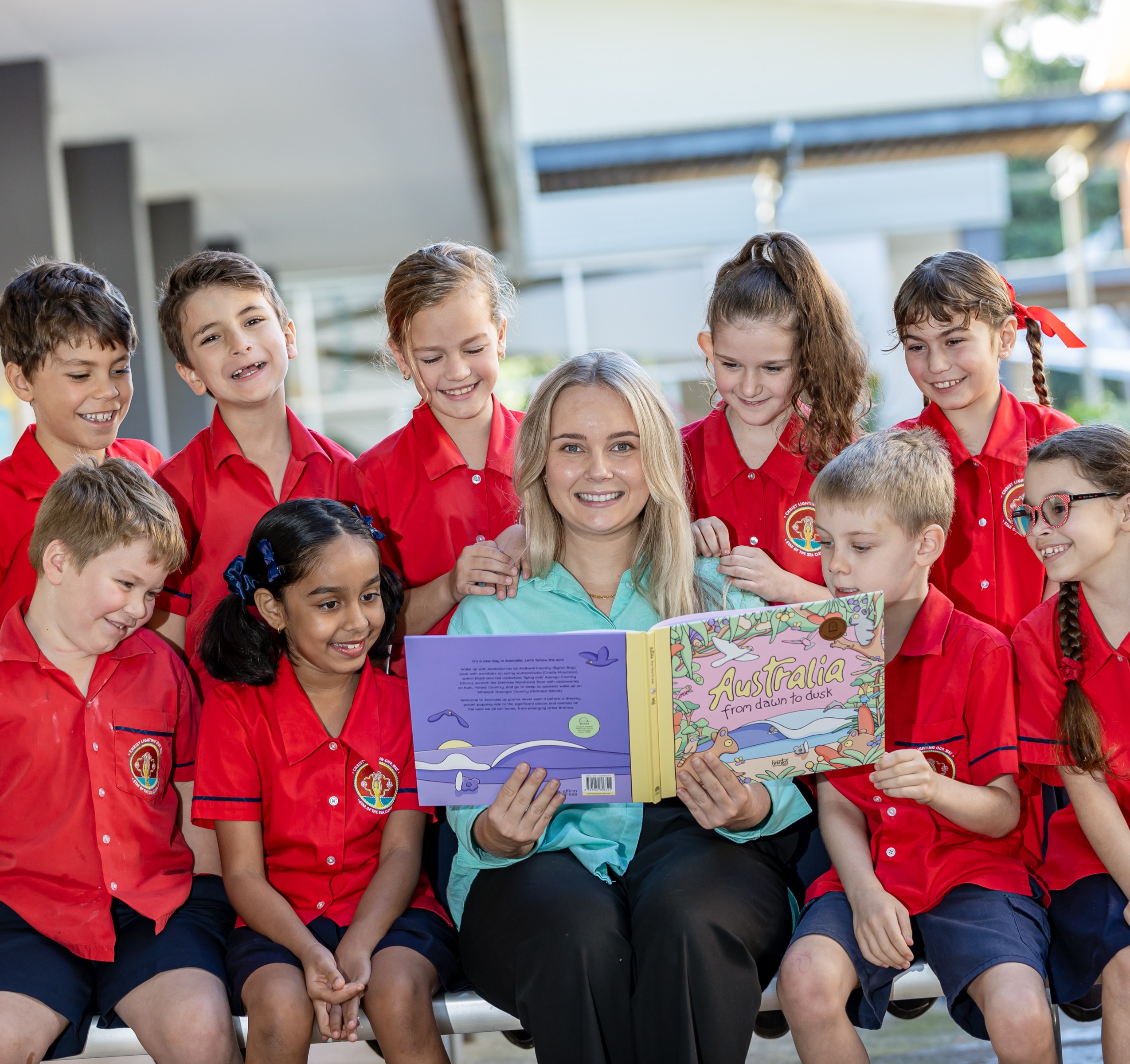 Teacher reading with a group of students encouraging engagement collaboration and a love of learning